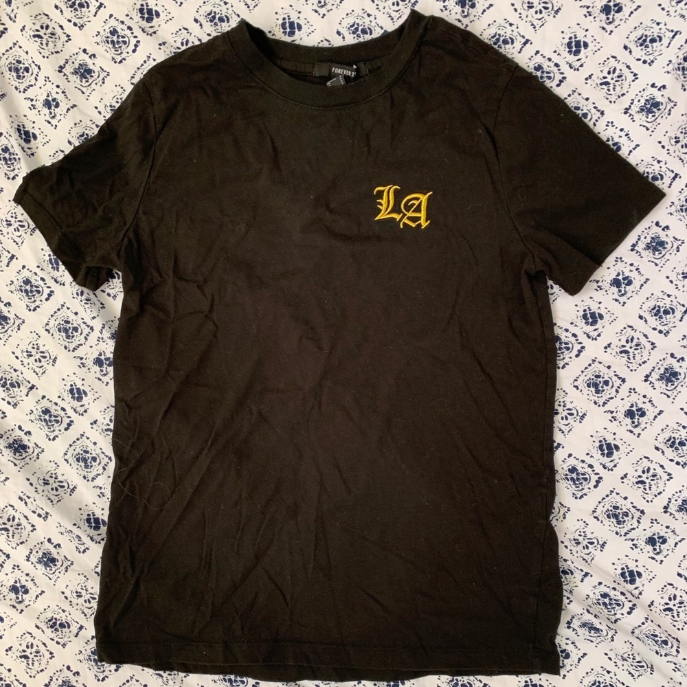 Black shirt with gold lettering